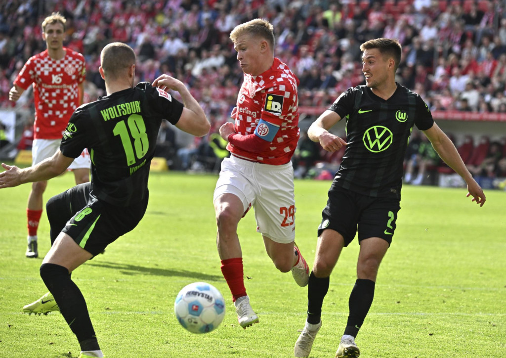 Slovák Denis Vavro (vľavo) a Kilian Fischer počas zápasu 30. kola nemeckej Bundesligy FSV Mainz - VfL Wolfsburg v Mainzi 19. apríla 2025. FOTO TASR/DPA
