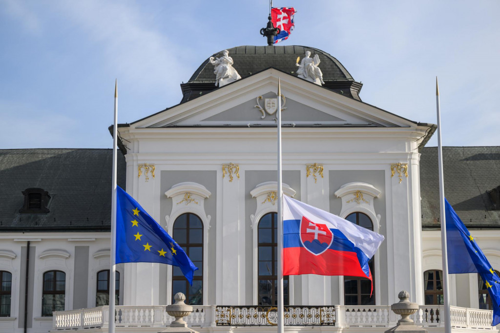 Na snímke vlajky Slovenskej republiky a Európskej únie, ktoré spustili príslušníci Prezidentskej čestnej stráže na pol žrde v súvislosti s úmrtím pápeža Františka pred Prezidentským palácom v Bratislave v utorok 22. apríla 2025. FOTO TASR - Jaroslav Novák