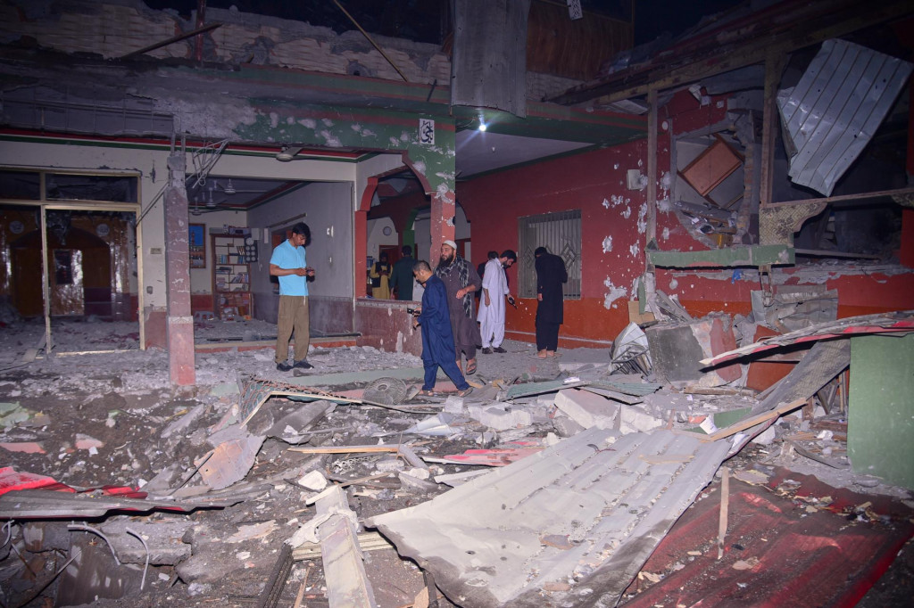 Miestni obyvatelia a miestni novinári si prezerajú budovu poškodenú po indickom raketovom útoku neďaleko Muzaffarabádu v pakistanskej časti Kašmíru. FOTO: TASR/AP