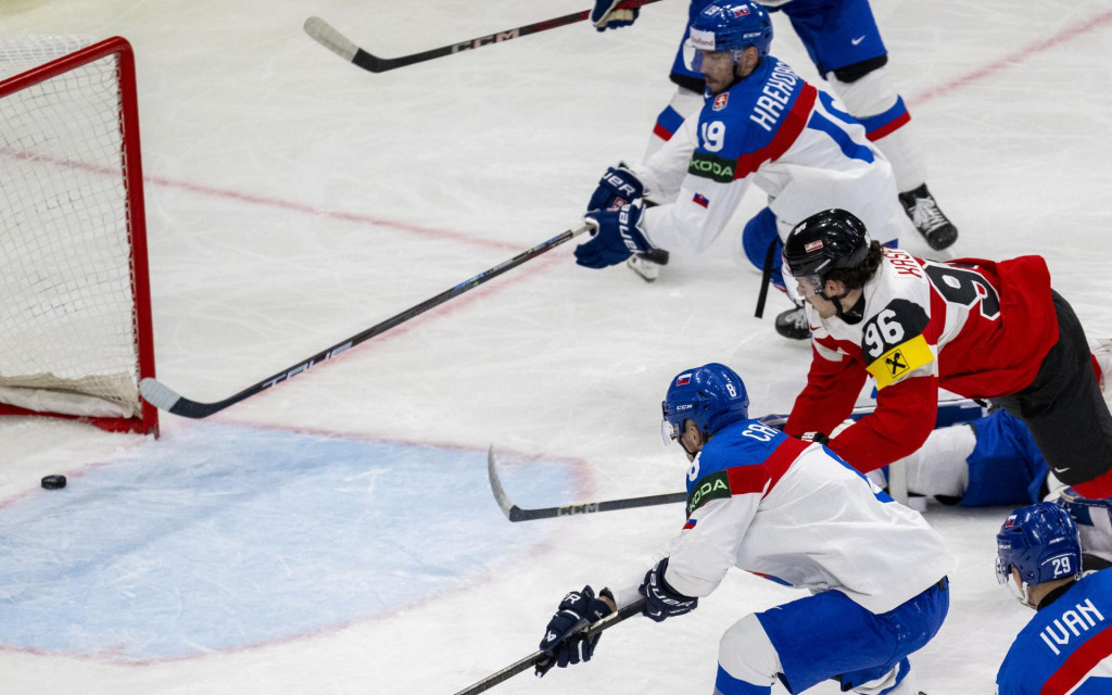 Na snímke zhora Patrik Hrehorčák (Slovensko), Marco Kasper (Rakúsko) strieľa gól a Maxim Čajkovič (Slovensko) počas zápasu základnej A-skupiny Rakúsko - Slovensko na 88. majstrovstvách sveta v ľadovom hokeji vo švédskom Štokholme. FOTO: TASR/Jakub Kotian