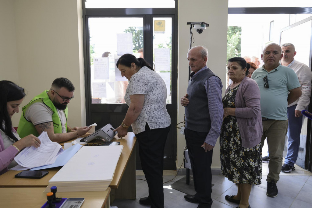 Na snímke ľudia stoja v rade, aby mohli odovzdať svoj hlasovací lístok počas parlamentných volieb v Tirane. FOTO: TASR/AP