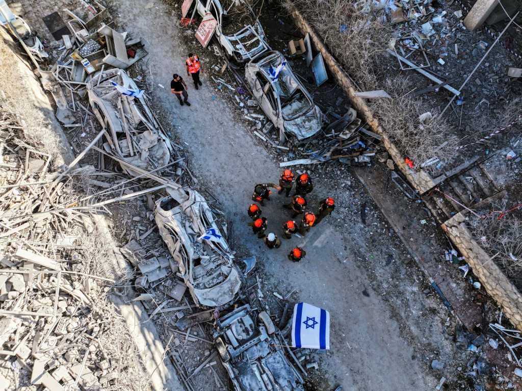 Záchranné sily na mieste dopadu po raketovom útoku z Iránu na Izrael v Ramat Gan v Izraeli. FOTO: Reuters