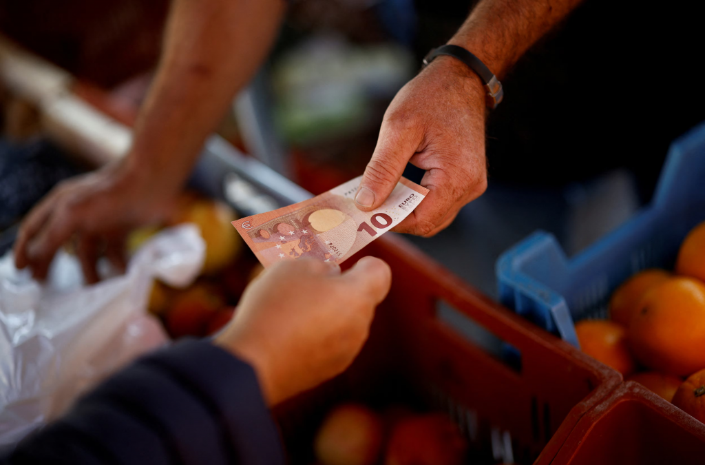 A shopper pays with a ten Euro bank note at a local market in Nantes, France, September 17, 2024. REUTERS/Stephane Mahe/File Photo FOTO: REUTERS