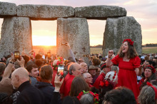 Tisíce ľudí sledovali východ slnka nad prehistorickým kamenným kruhom Stonehenge. FOTO: Reuters