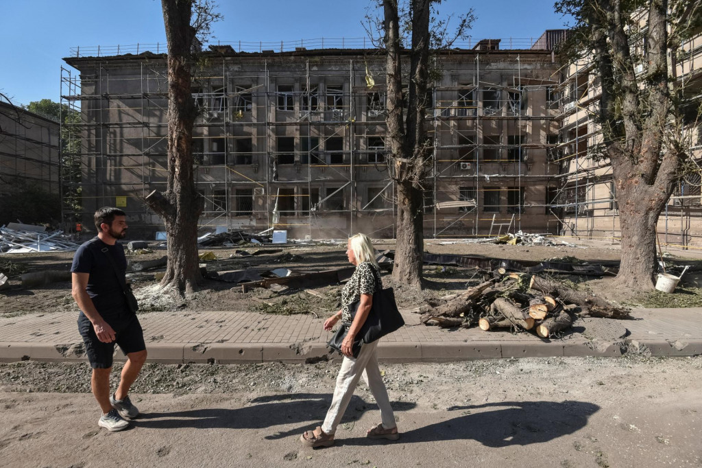 Ľudia kráčajú po areáli nemocnice, ktorá bola zasiahnutá ruským raketovým útokom uprostred ruského útoku v ukrajinskom meste Kamjanske​. FOTO: Reuters