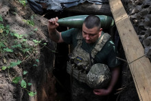 Ukrajinský vojak nesie granát pre samohybnú húfnicupred streľbou na ruské jednotky na frontovej líni v Doneckej oblasti. FOTO: Reuters