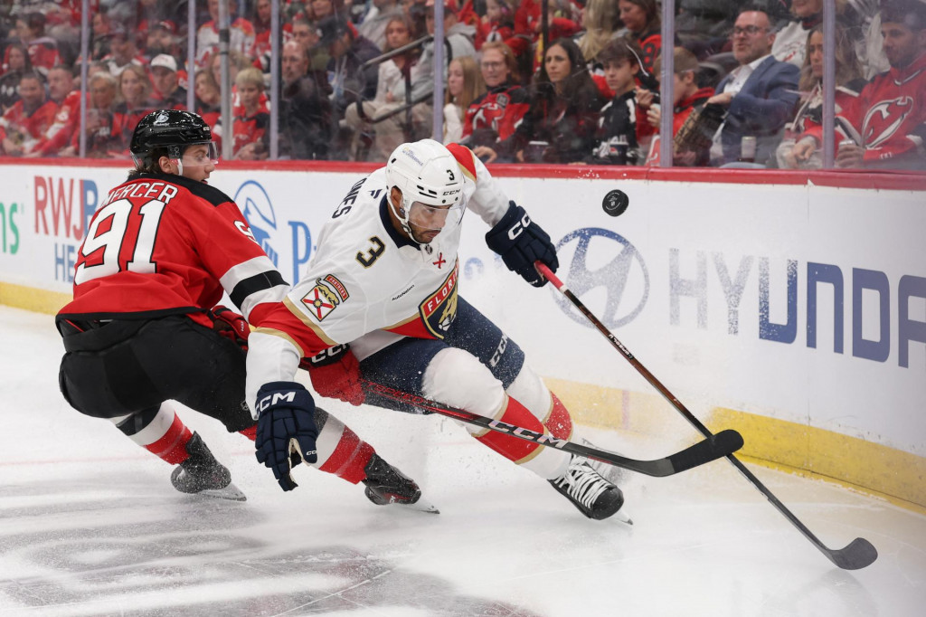 Obranca tímu Florida Panthers Seth Jones (3) a center tímu New Jersey Devils Dawson Mercer (91) bojujú o puk počas druhej tretiny. FOTO: Ed Mulholland/Imagn Images