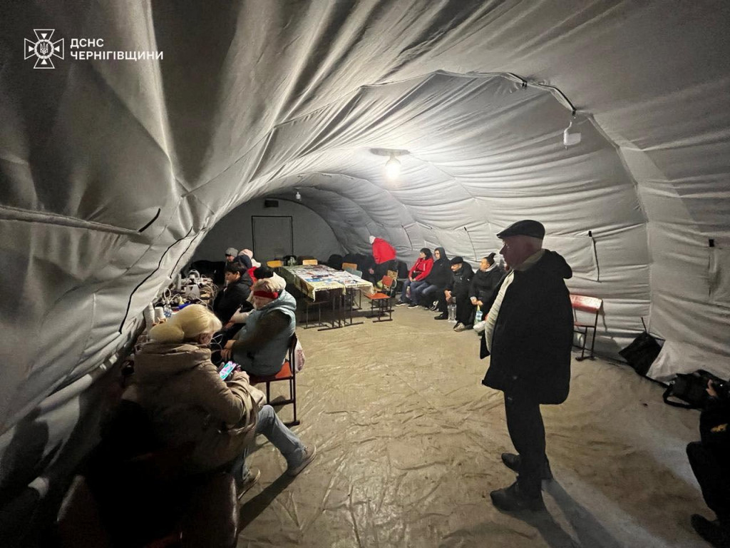 Ľudia si nabíjajú zariadenia, používajú internetové pripojenie a zohrievajú sa v centre nedobytnosti po tom, čo bola v Černihivskej oblasti na Ukrajine zasiahnutá kritická infraštruktúra. FOTO: Reuters/Štátna záchranná služba Ukrajiny