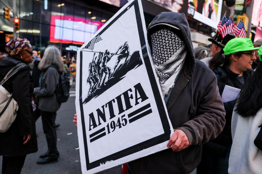 Demonštrant drží transparent s nápisom „antifa“ na proteste „Žiadni králi“ proti politike amerického prezidenta Donalda Trumpa na Times Square v New Yorku. FOTO: Reuters