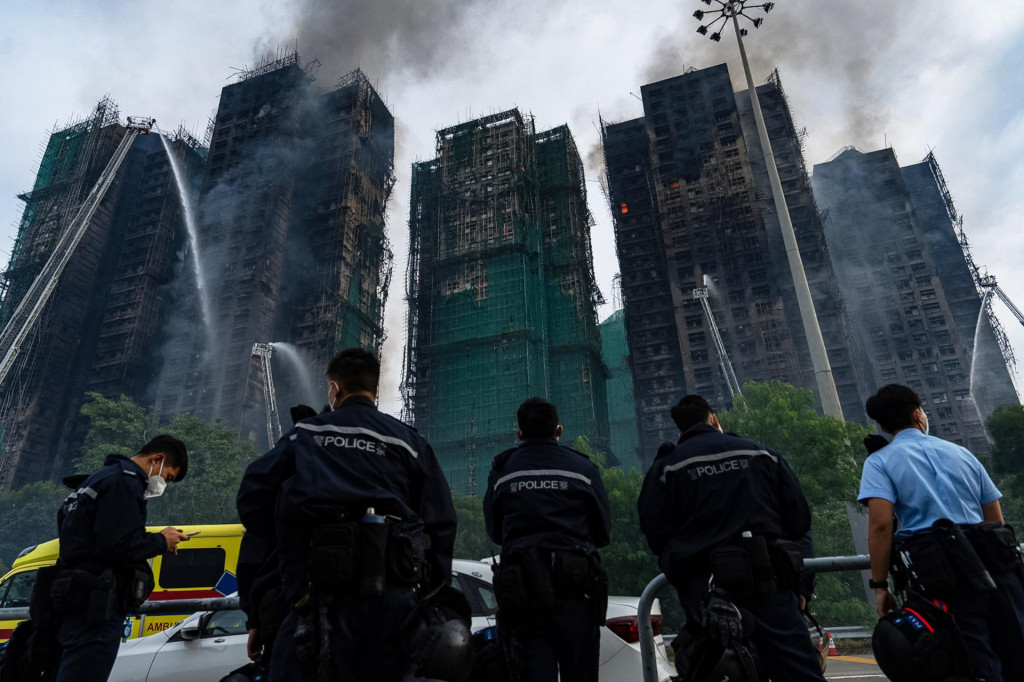 Hasiči zasahujú na mieste požiaru výškového obytného komplexu v mestskej štvrti Tchaj Po na severe Hongkongu. FOTO: TASR/AP