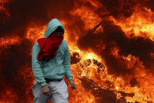 Demon&scaron;trant kr&aacute;ča pred zap&aacute;len&yacute;mi pneumatikami neďaleko Eur&oacute;pskeho parlamentu. FOTO: REUTERS