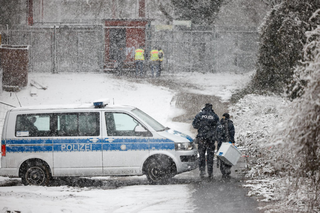 Policajti kr&aacute;čaj&uacute; pred rozvodnou sieťou elektrickej energie v Berl&iacute;ne v Nemecku, ktor&aacute; sa vznietila a sp&ocirc;sobila v&yacute;padok pr&uacute;du v niektor&yacute;ch častiach mesta. FOTO: