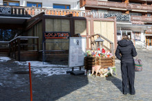Žena stoj&iacute; pred barom v luxusnom &scaron;vajčiarskom lyžiarskom stredisku Crans Montana ležiacom v kanton&aacute;lne Valais, kde pri novoročnom požiari zahynulo 40 ľud&iacute;. FOTO: TASR/AP