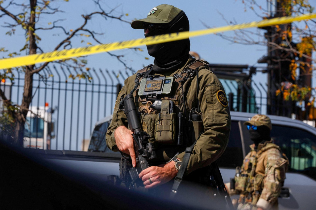 Pr&iacute;slu&scaron;n&iacute;k americkej hraničnej hliadky stoj&iacute; za p&aacute;skou počas stretu demon&scaron;trantov s americkou imigračnou a colnou spr&aacute;vou (ICE). FOTO: Reuters