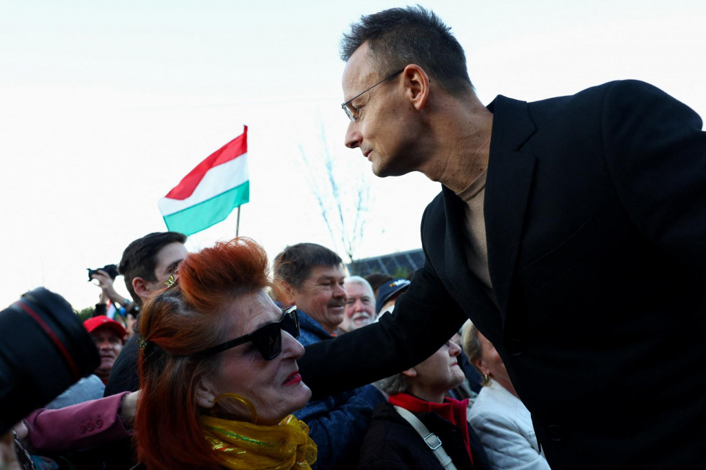 Maďarsk&yacute; minister zahraničn&yacute;ch vec&iacute; P&eacute;ter Szijj&aacute;rt&oacute; v&iacute;ta ľud&iacute; počas protestu proti tomu, čo organiz&aacute;tori naz&yacute;vaj&uacute; &bdquo;ukrajinsk&yacute;m vydieran&iacute;m&ldquo; v Budape&scaron;ti v Maďarsku. FOTO: Reuters