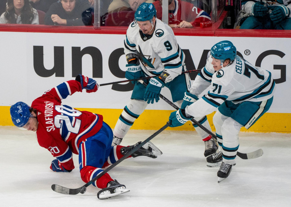 Slovensk&yacute; hokejista Montrealu Juraj Slafkovsk&yacute; (vľavo) a hr&aacute;č San Jose Macklin Celebrini (vpravo) bojuj&uacute; o puk v z&aacute;pase z&aacute;morskej NHL Montreal - San Jose v Montreale. FOTO: TASR/AP