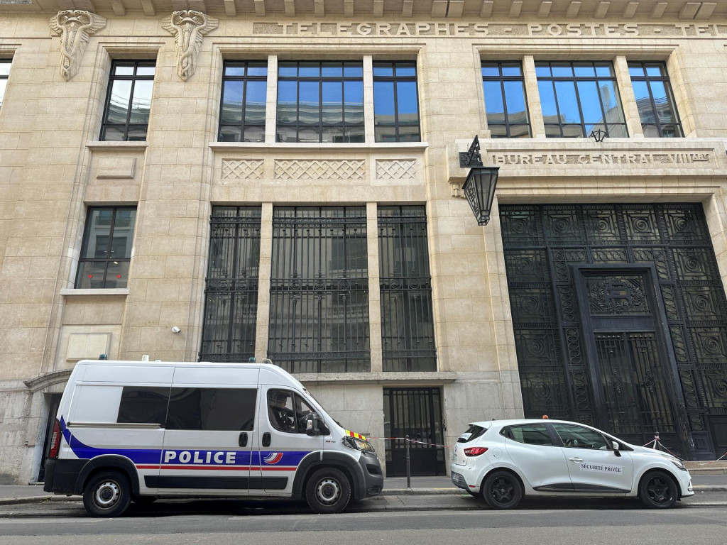 Pred budovou, v ktorej s&iacute;dli Bank of America v Par&iacute;ži, je vidieť policajn&uacute; dod&aacute;vku. FOTO: Reuters
