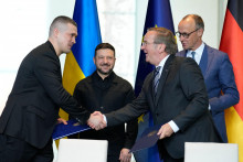 Nemeck&yacute; kancel&aacute;r Friedrich Merz (druh&yacute; sprava), ukrajinsk&yacute; prezident Volodymyr Zelenskyj (druh&yacute; zľava), ukrajinsk&yacute; minister obrany Mychajlo Fedorov (vľavo) a nemeck&yacute; minister obrany Boris Pistorius (vpravo) si pod&aacute;vaj&uacute; ruky po podpise doh&ocirc;d počas nemecko-ukrajinsk&yacute;ch vl&aacute;dnych konzult&aacute;ci&iacute; v Berl&iacute;ne v utorok 14. apr&iacute;la 2026. FOTO TASR/AP
