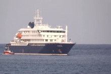 Loď vedľa v&yacute;letnej lode MV Hondius zakotvenej pri pr&iacute;stave Kapverd. FOTO: Reuters