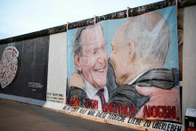 B&yacute;val&yacute; nemeck&yacute; kancel&aacute;r Gerhard Schroeder a rusk&yacute; prezident Vladimir Putin vyobrazen&iacute; na graffiti, ako si d&aacute;vaj&uacute; bozk v East Side Gallery v Berl&iacute;ne. FOTO: Reuters