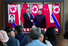 Na telev&iacute;znej obrazovke fotografia severok&oacute;rejsk&eacute;ho vodcu Kim Čong-una a č&iacute;nskeho prezidenta Si Ťin-pchinga na železničnej stanici v Soule. FOTO: TASR/AP