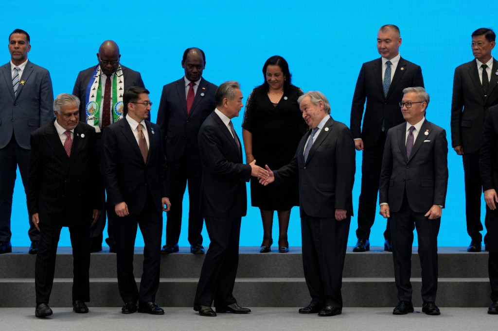 Č&iacute;nsky minister zahraničn&yacute;ch vec&iacute; Wang I a gener&aacute;lny tajomn&iacute;k OSN Ant&oacute;nio Guterres si pod&aacute;vaj&uacute; ruky pred spoločn&yacute;m fototen&iacute;m po podpise dohody o založen&iacute; Svetovej organiz&aacute;cie pre spolupr&aacute;cu v oblasti umelej inteligencie. FOTO: TASR/AP