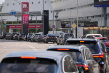 Aut&aacute; čakaj&uacute; v rade na čerpacej stanici Lukoil v Moskve. FOTO: TASR/AP