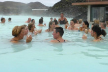 N&aacute;v&scaron;tevn&iacute;ci si vychutn&aacute;vaj&uacute; drink v geoterm&aacute;lnych k&uacute;peľoch Blue Lagoon v Grindav&iacute;ku na Islande. FOTO: Reuters