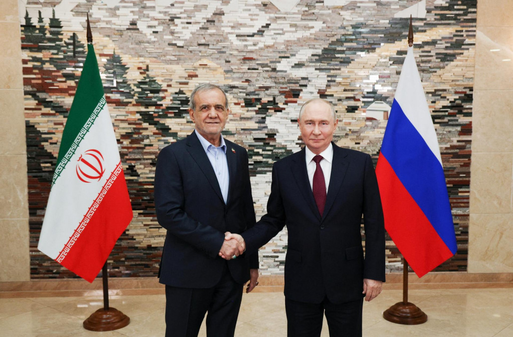 Rusk&yacute; prezident Vladimir Putin si pod&aacute;va ruku s ir&aacute;nskym prezidentom Mas&uacute;dom Peze&scaron;kij&aacute;nom. FOTO: Reuters