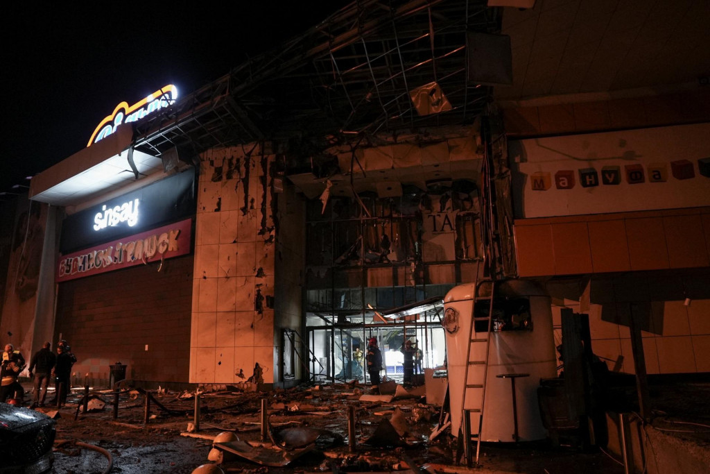 Z&aacute;chran&aacute;ri pracuj&uacute; pri n&aacute;kupnom centre, ktor&eacute; zasiahol večern&yacute; &uacute;tok rusk&eacute;ho dronu. FOTO: Reuters